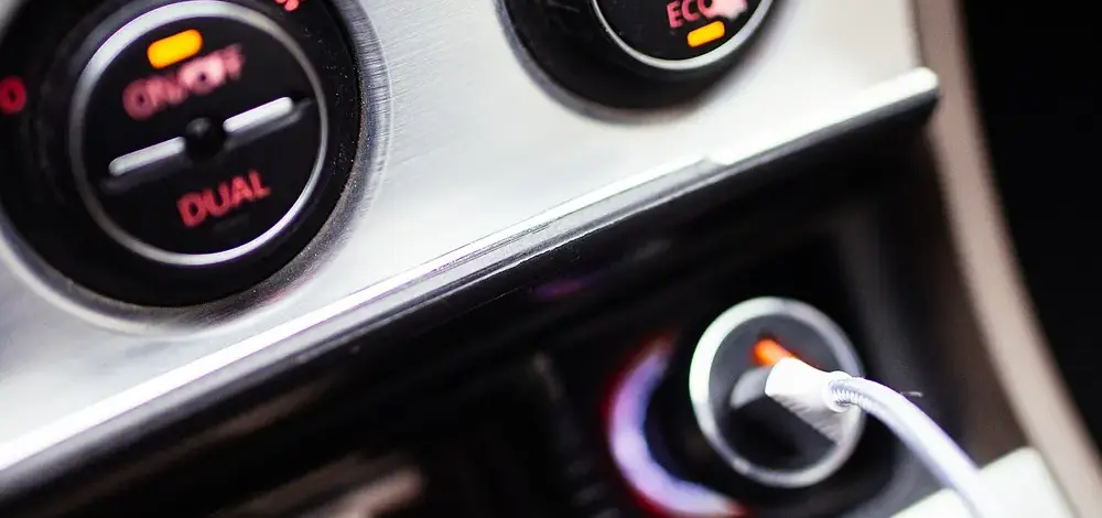 Can I Keep My Car in Chapter 7? Three Options, Explained — Car interior close-up with dashboard controls and charging cable