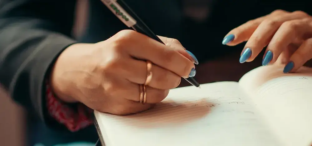 How to File Chapter 7 Without a Lawyer: The Full Sequence — Businesswoman writing in a notebook closeup