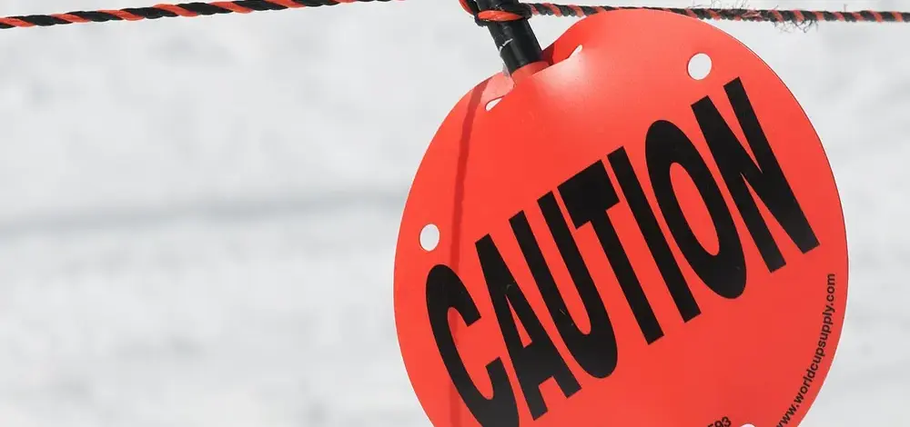 Is Debt Relief Legit? How to Tell in Three Questions — Caution sign on ski slope